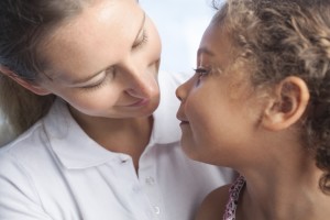 woman looks lovingly at child