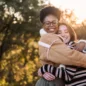 two lovely friends hugging in nature at sunset 2023 11 27 05 15 05 utc