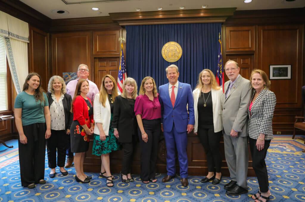 Caption: Partner Lila Bradley (second from left) at the signing of SB 100 (Andee's Law) with Governor Brian Kemp, celebrating the restoration of adoptee birth certificate rights in Georgia.